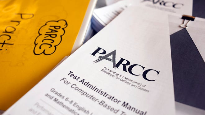 PARCC officials will consolidate two testing windows and reduce the test by 90 minutes. A PARCC practice test books sit on a table in this file photo.