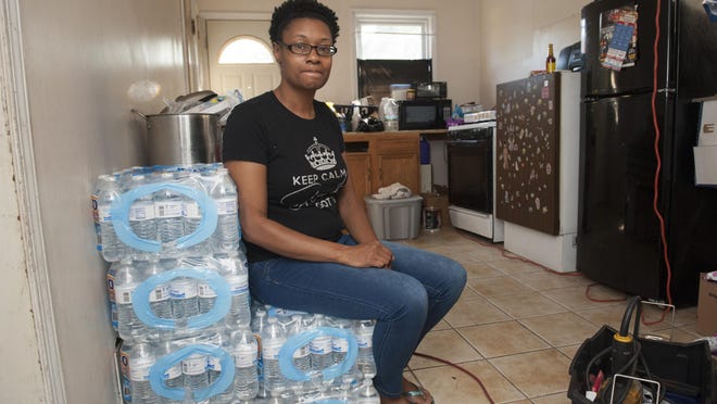 LaToya Jones said she and husband Jay Moore have been relying on bottled water almost since moving into their east-side home on May 11. Hers is among 13,750 residences that have lost water service since April.