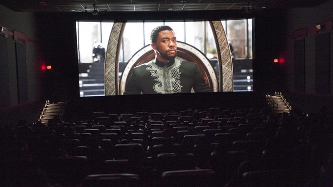 Actor Chadwick Boseman as the Black Panther appears on the big screen at Bel Air Luxury Cinema in Detroit during a special viewing of the film by Detroit students.