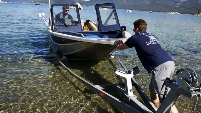 Andrew Cobourn, left, and Brian Limacher launch a Nevada State Park boat into Lake Tahoe on June 15, 2014. The launch won’t open this year unless water level rises.