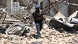 A member of the Iraqi forces walks amidst the rubble