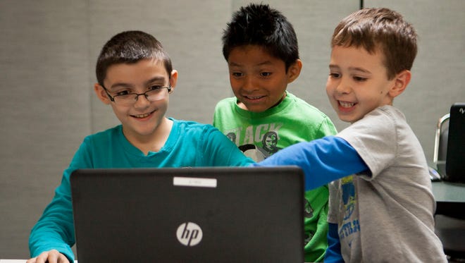 Anthony Dhondt (from left), 9, Cruz Rich, 8, and Ryne Reighley, 6, play their self-coded versions of the video game Minecraft. The summer camp/class is called CodaKid, and is one of more than 1,500 in the azcentral.com database.