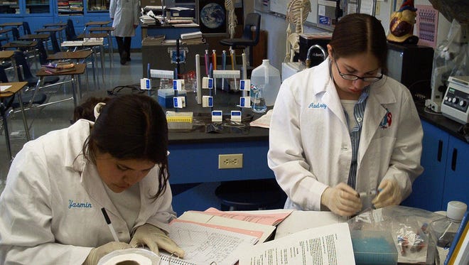 Yasmin Cervantes, left, and Audrey Hernandez are busy on DNA protocol work on the bi-state sage grouse in the Yerington High School DNA class in the early 2000s. The 2015-16 school year began Monday.