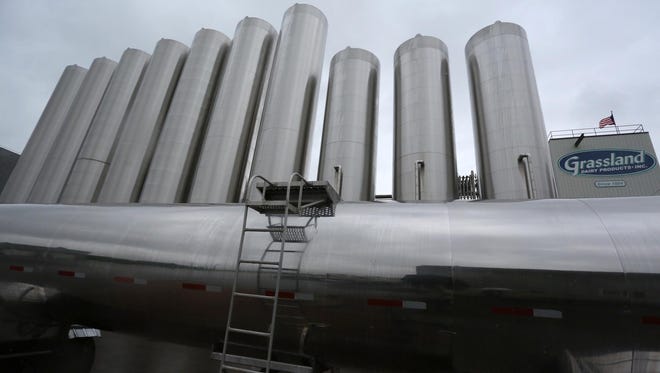 Stainless steel tanks tower over a milk semi truck at Grassland Dairy Products near Greenwood. Wisconsin's role as a major milk-producing state has profound implications for the prices dairy farmers get for their product.