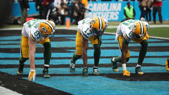 Green Bay Packers receivers Jordy Nelson (87), Davante Adams (17) and Geronimo Allison (81) celebrate Adams' first-quarter touchdown with a race walk on Sunday, Dec. 17, 2017, at Bank of America Stadium in Charlotte, N.C.