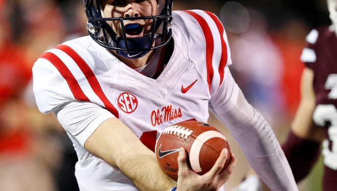Ole Miss quarterback Chad Kelly lunges forward with the ball for a 27-yard touchdown run in the first half of the Egg Bowl Saturday. Ole Miss cruised to a rout of rival Mississippi State.