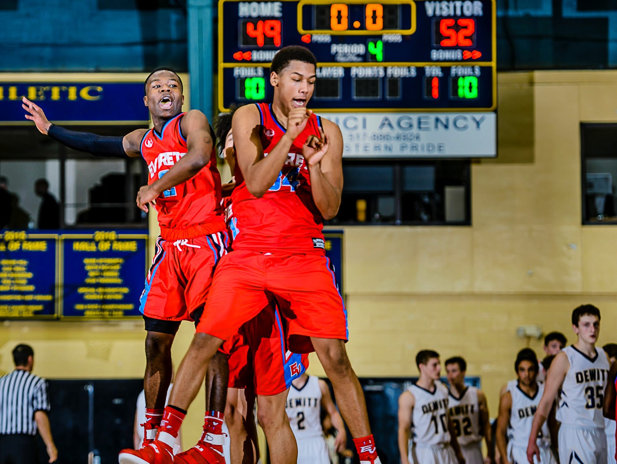 Nyreel Powell ,left, of Everett and teammate Diego Robinson celebrate after their Class A district semifinal win over DeWitt Wednesday March 8, 2017 at Don Johnson Fieldhouse in Lansing.