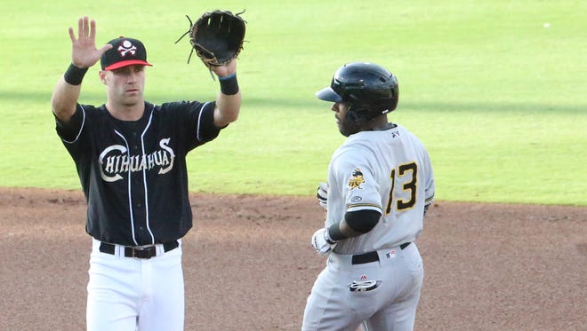 Chihuahuas short stop Dusty Coleman asks a teammate to refrain from throwing as Salt Lake Bees baserunner Rey Navarro arrives safely at second base Thursday night. 