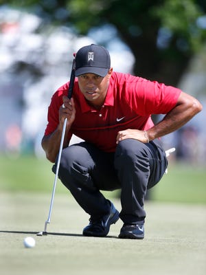 FILE - In this Feb. 25, 2018, file photo, Tiger Woods lines up a putt on the fourth hole during the final round of the Honda Classic golf tournament,in Palm Beach Gardens, Fla. Woods decided to add next week’s Valspar Championship to his golf schedule leading up to the Masters. (AP Photo/Wilfredo Lee, File)