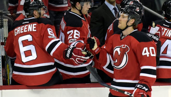 New Jersey Devils center Blake Coleman (40) celebrates his first NHL goal with Andy Greene (6) and Damon Severson (28) during the first period of an NHL hockey game against the Dallas Stars, Sunday, March 26, 2017, in Newark, N.J. (AP Photo/Bill Kostroun)