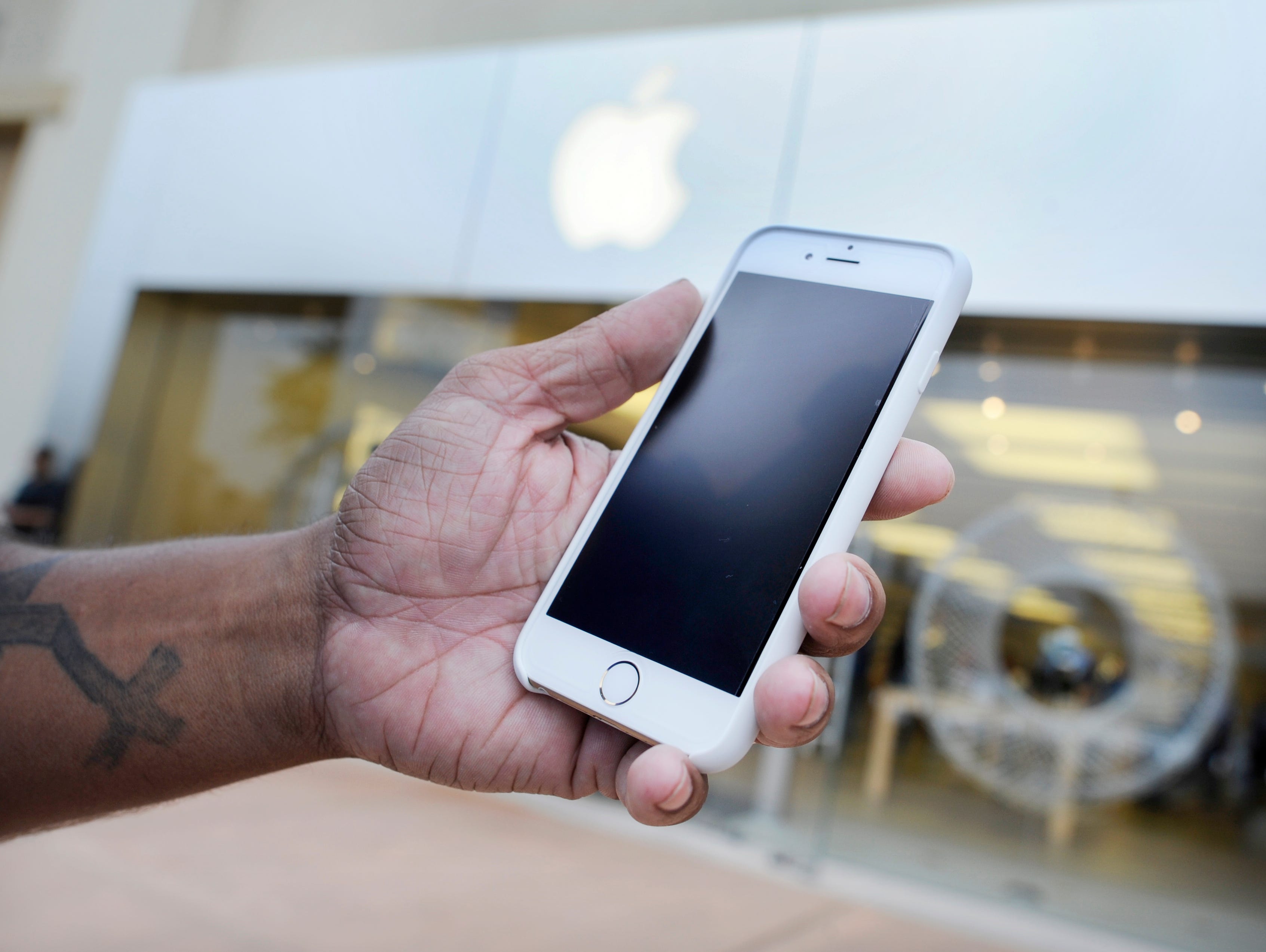Josh Nolan holds his new iPhone 6 at an Apple Store in Augusta, Ga., in 2014.