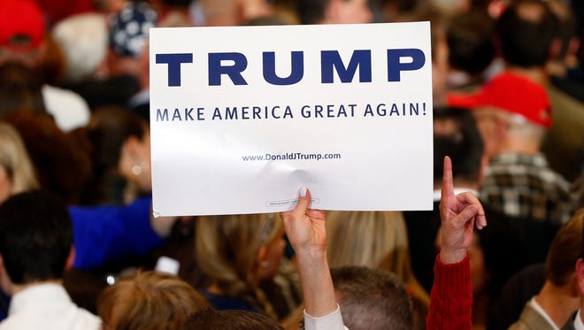 A supporter holds up a sign for Donald Trump during a South Carolina Republican primary night event on Feb. 20, 2016, in Spartanburg, S.C.