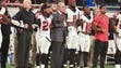 Falcons owner Arthur Blank stands with players during