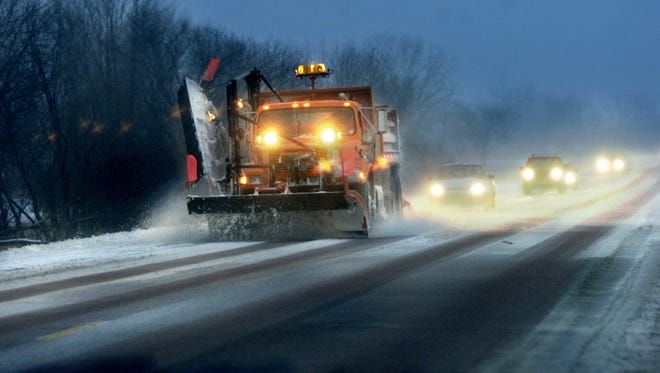 In this undated file photo, a Johnson County snow plow is followed by a line of motorists on Highway 1 southwest of Iowa City.