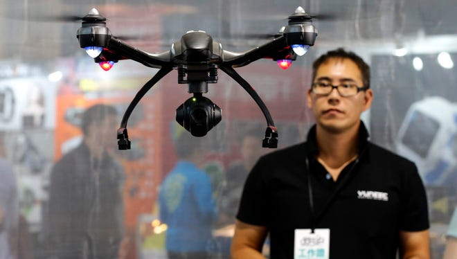 An exhibitor operates a Yuneec Typhoon Q500 4K drone during a computer show in Taipei, Taiwan, on April 15, 2016.