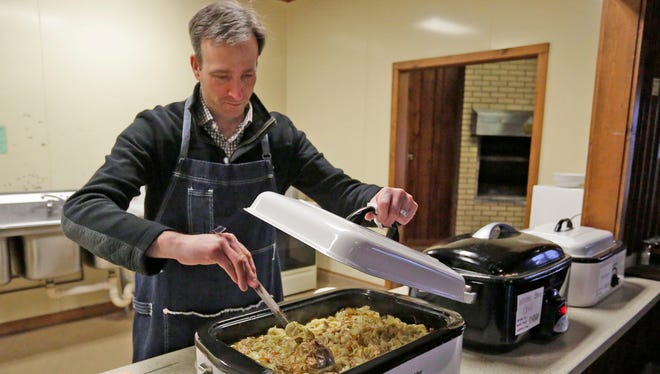 Adam DuSombre, a volunteer at Sheboygan SOUP, stirs chicken noodle soup before the event Thursday April 27, 2017 at Kiwanis Park in Sheboygan, Wis. 