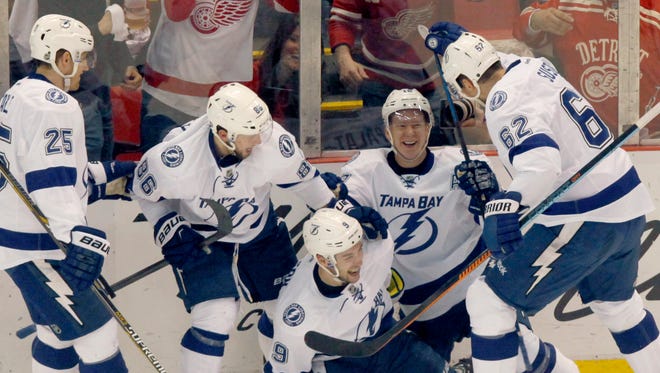 The Lightning celebrate a goal by Tyler Johnson during the second period Monday at Joe Louis Arena.