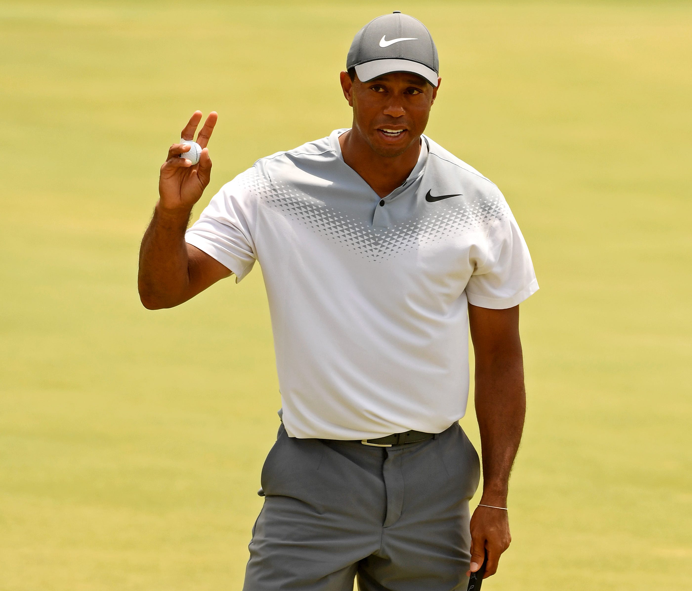 Tiger Woods waves to the gallery after completing his third round at The Players Championship on the Stadium Course at TPC Sawgrass.