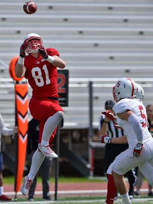 St. John's tight end Jared Streit (81) catches a pass over white team defenders in the first half Saturday, April 30, at Clemens Stadium.