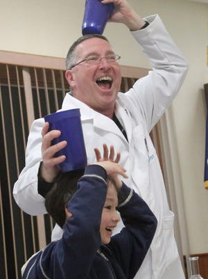 Mad Scientist Joltin' Pszonek from Mad Science gets some help with one of his experiments from Donovan Chang, 8, of Morristown during the Mother Son Fun Night in Morris Twp, NJ, on Friday, February 27, 2015.Dawn J. Benko for the Daily Record
