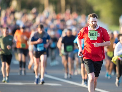 Adney Cross runs along Neyland Dr. in the half marathon
