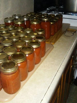 The Eichers have been busy canning pizza sauce using tomatoes from their garden.