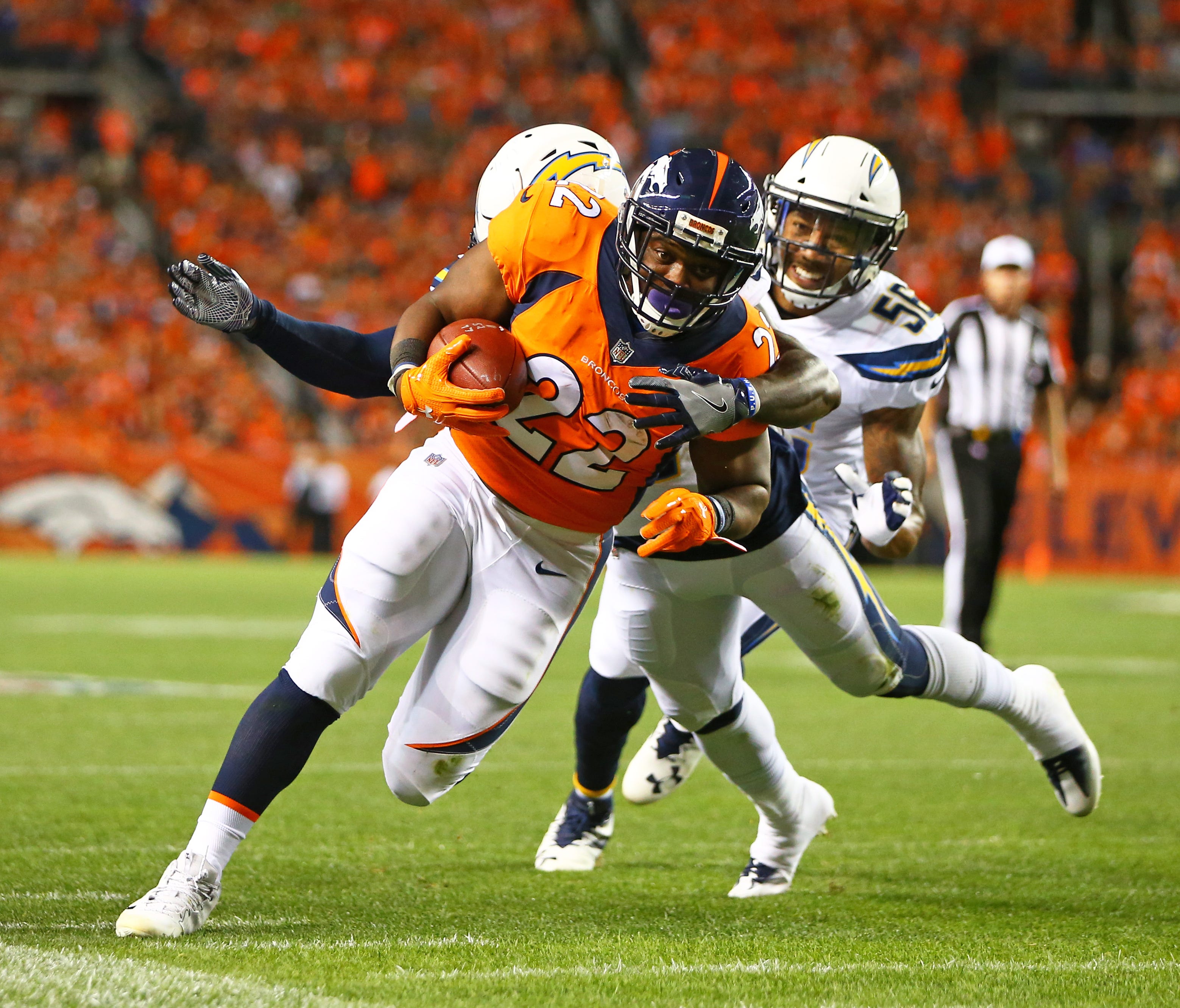 Denver Broncos running back C.J. Anderson runs the ball in the first quarter against the Los Angeles Chargers at Sports Authority Field in Denver.