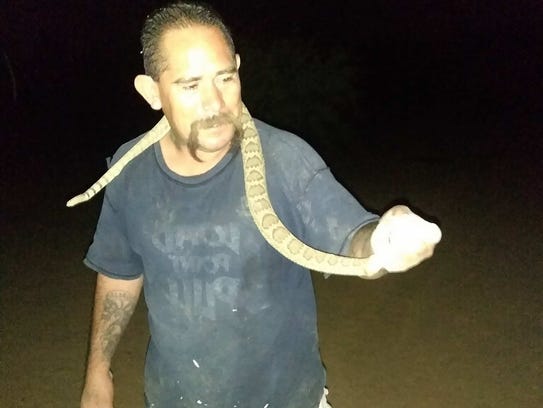 Victor Pratt caught the rattlesnake and posed for several