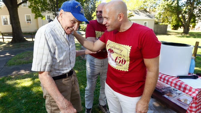 Boonton Mayor Matthew DiLauri, r, thanks WWII Veteran Rudolph Sova for donating a photo of himself from 1946 before a time capsule interment at Mayor's Park, the capsule will be opened in 2117. September 23, 2017, Boonton, NJ