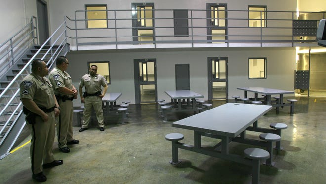 El Paso County Jail Annex detention officers stand in one of the units inside the facility at 12501 E. Montana Ave.