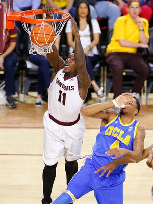 Arizona State Sun Devils forward Savon Goodman (11) shoots over UCLA Bruins guard Norman Powell (4) during the first half of their NCAA basketball game Wednesday, Feb. 18, 2015 in Tempe,  Ariz.