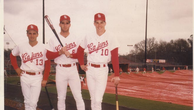 UL standouts Ken Meyers (13), Damian Grossie (8) and Tommy Bates (10) pose on top of the first base dugout in preparation for the memorable 1991 season.