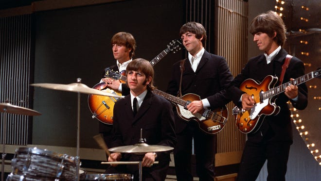 The Beatles prepare before a 1966 performance in a TV studio in London.