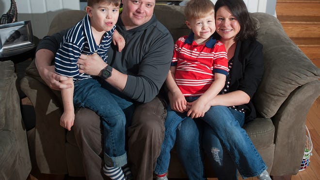 Kelly and Ryan Sexton interact with their two sons, 5-year-old Logan, left, and 6-year-old Dylan, right, who share the same incredibly rare medical disorder called MED13L. The boys have developmental delays and behavioral issues, as well as problems with their physical development.