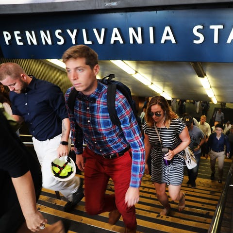 Commuters exit Penn Station on the first morning o