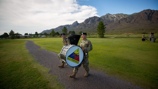 Members of the 1st Armored Division Band based at Fort Bliss, TX, walk at the White Sands Missile Range after a Change of Command ceremony, Thursday, August 25, 2016.