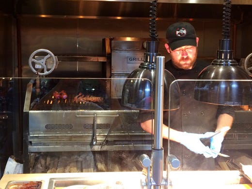 Chef prepares meal at Tres Gauchos Grill