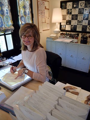 Claire Frascogna, calligrapher and owner of Scripted Calligraphy, writes at her home office in Madison.