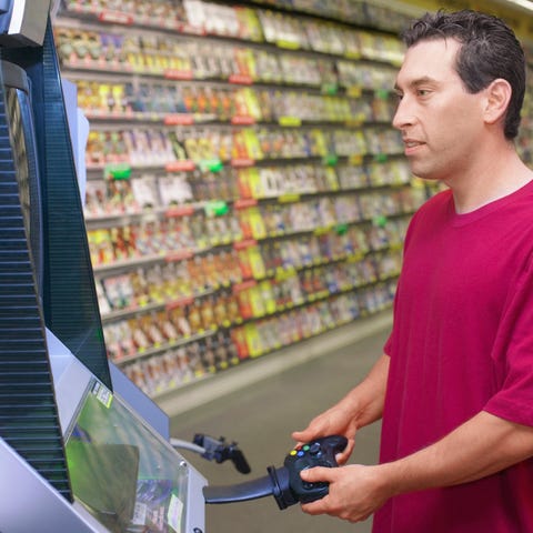 Man playing video game in video game store