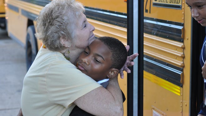 Linda Dubroc, whose grandson attends Peabody Montessori  Elementary School, greets students with a hug as they arrive at the school one morning each week. Peabody's Parent Teacher Organization recruits grandparents to greet kids every day.