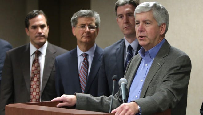 Governor Rick Snyder makes an announcement to switch the Flint water system back to Detroit during a press conference on Thursday, Oct. 8, 2015, at the Mott Foundation / Commerce Center Building in downtown Flint.