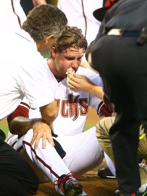April 28, 2015; Phoenix; Arizona Diamondbacks pitcher Archie Bradley is tended to by trainers after being hit in the face by a line drive in the second inning against the Colorado Rockies at Chase Field.