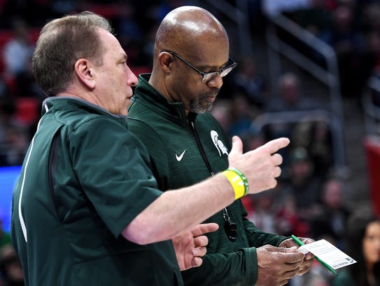Michigan State's assistant coach Mike Garland, right,