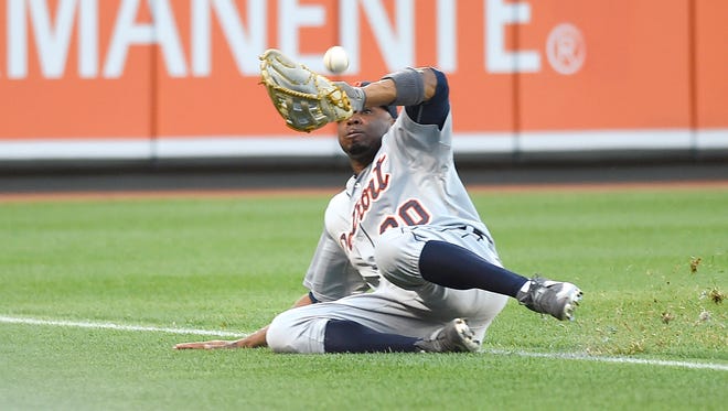 Tigers centerfielder Rajai Davis attempts to make catch on Orioles rightfielder Chris Davis foul ball during the first inning of the Tigers' 8-7 loss Friday in Baltimore.