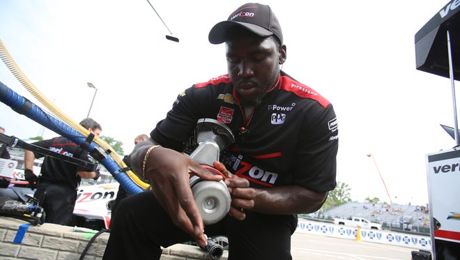 Quinton Washington, the refueler for IndyCar driver Will Power,applies lubrication to his refueling rig before the first practice at the 2015 Chevrolet Detroit Belle Isle Grand Prix in Detroit on Friday, May 29, 2015.