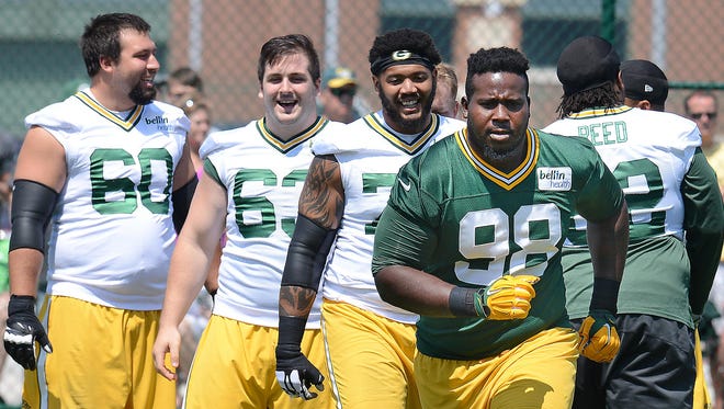 Green Bay Packers defensive tackle Letroy Guion (98) runs Wednesday during organized team activities.