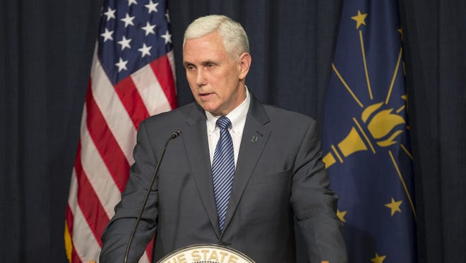 Mike Pence, Indiana Governor, speaks to press members following his signing of the state's Religious Freedom Restoration Act, Thursday, March 26, 2015.