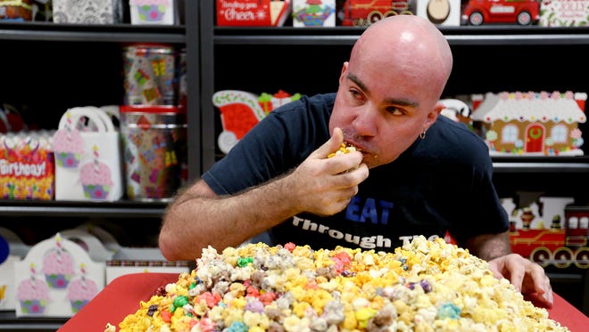 Competitive eater Ryan Rodacker of Salem attempts to eat 8.7 pounds of flavored popcorn in 30 minutes at Popcorn Fetti in December. He ate nearly 2 pounds. Rodacker and reporter Tom Mayhall Rastrelli will complete a food challenge at the Hitchin' Post in Keizer on March 8 for the reporter's column "Keep Salem Weirder."