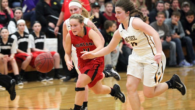Highland's Cheyann Adamson, left, and Lone Tree's Elena Sieverding chase down a loose ball during their game in Lone Tree on Tuesday, Dec. 15, 2015.
