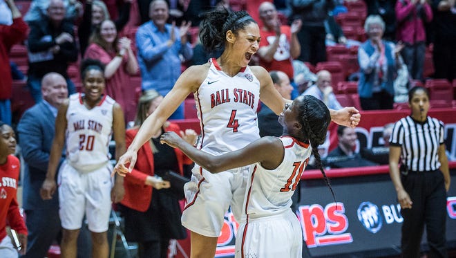 Ball State's Nathalie Fontaine celebrates with teammates after breaking the school's all-time scoring record during their game against Northern Illinois Wednesday, March 2, 2016. 